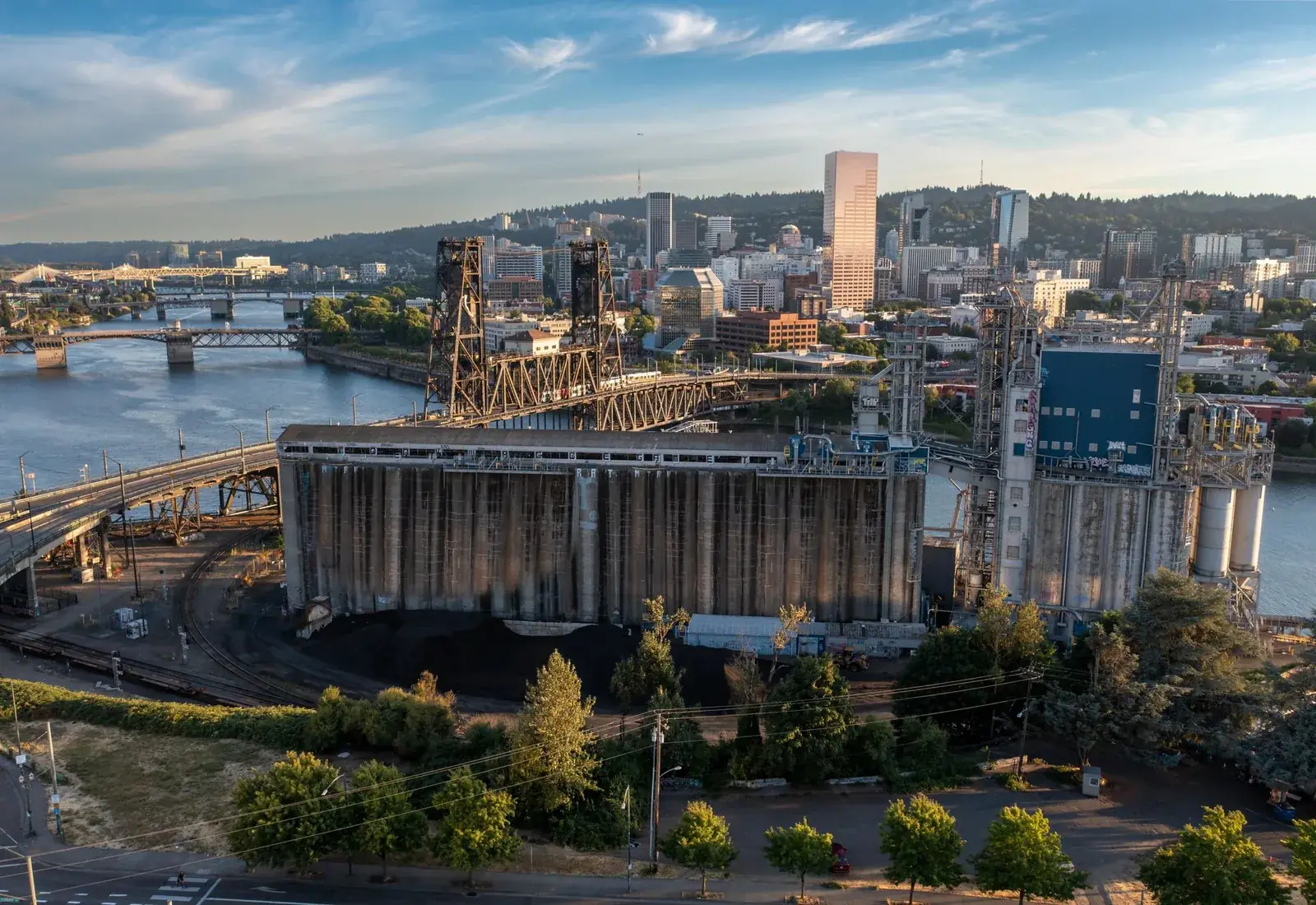 The Portland skyline and the Steel Bridge over the Willamette River at sunset